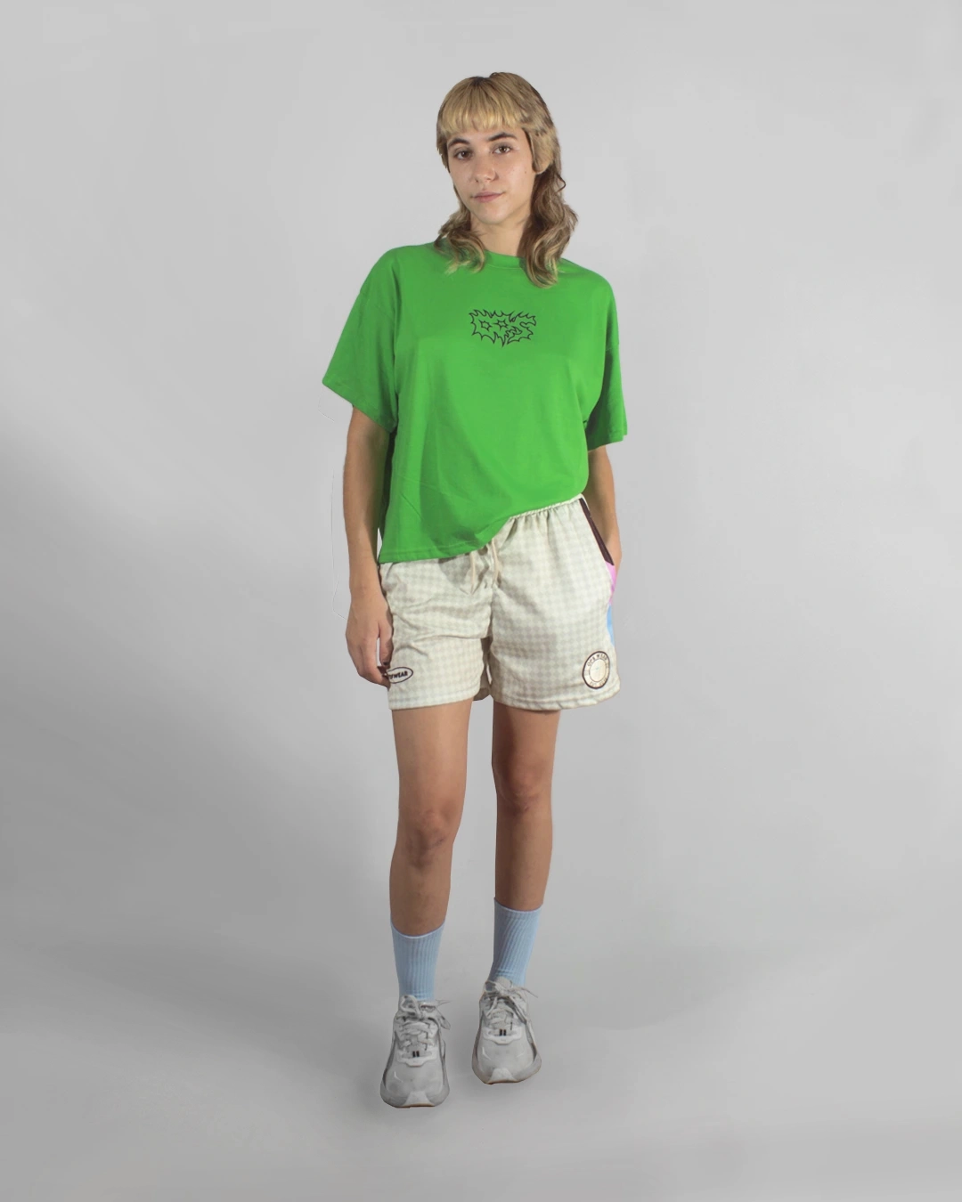 modelo usando remera unknow verde washed boxi fit outfit completo con medias celeste zapatillas deoprtivas